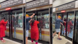 Woman in Salwar Kameez Tries to Squeeze Through Automatic Doors of Train